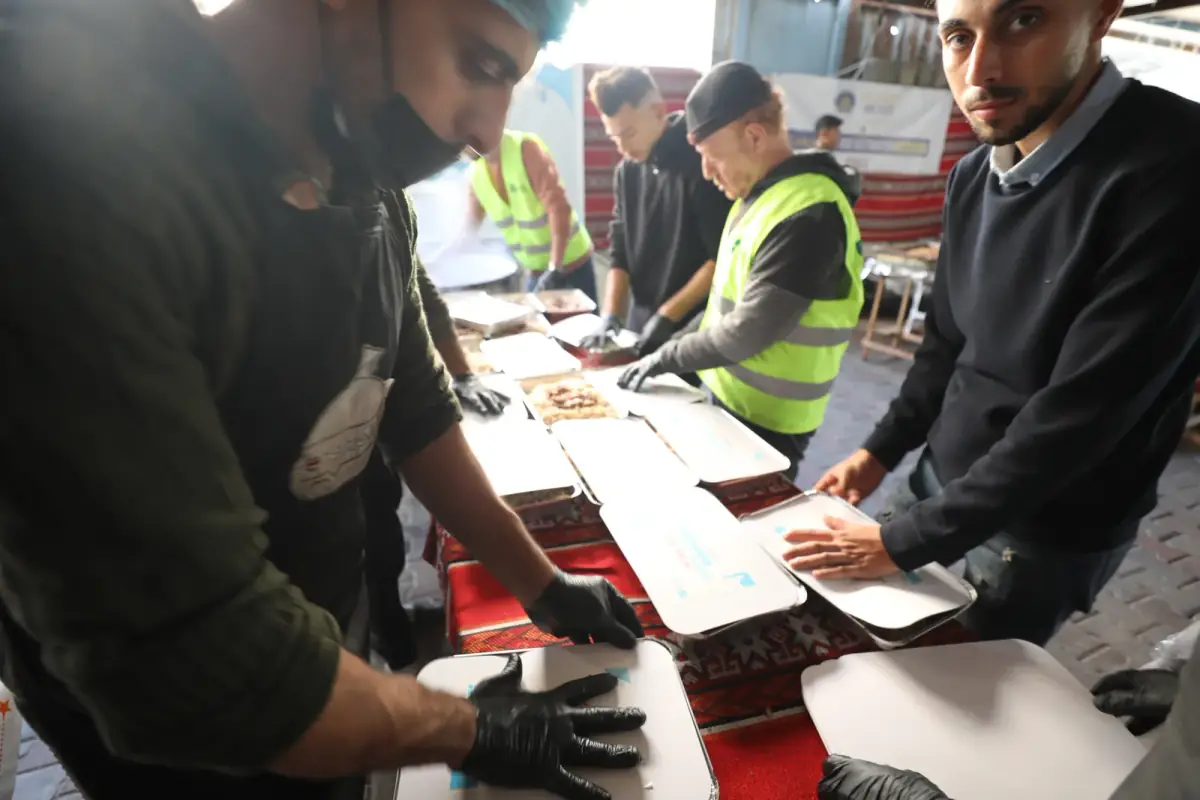 CBB volunteers packing and sealing individual meal boxes in Gaza