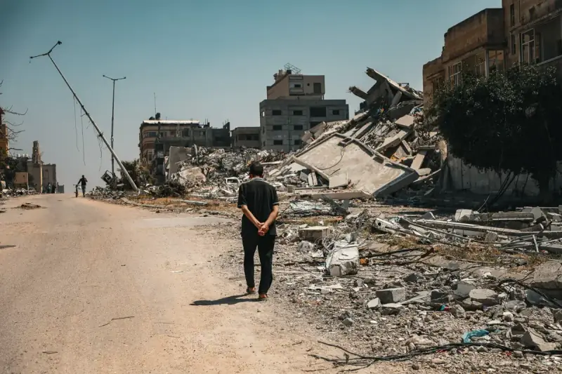 A man walks alone through the rubble of a destroyed Gaza neighbourhood